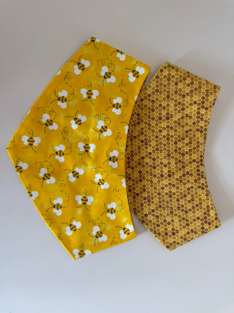 Bizzy Bee reversible pet bandana showing bee and honeycomb sides