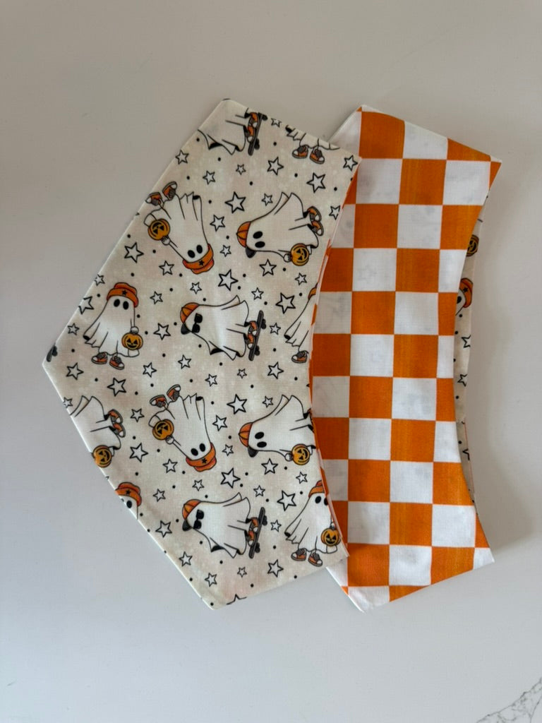 Boo Crew reversible Halloween pet bandana showing ghost and orange checkerboard sides